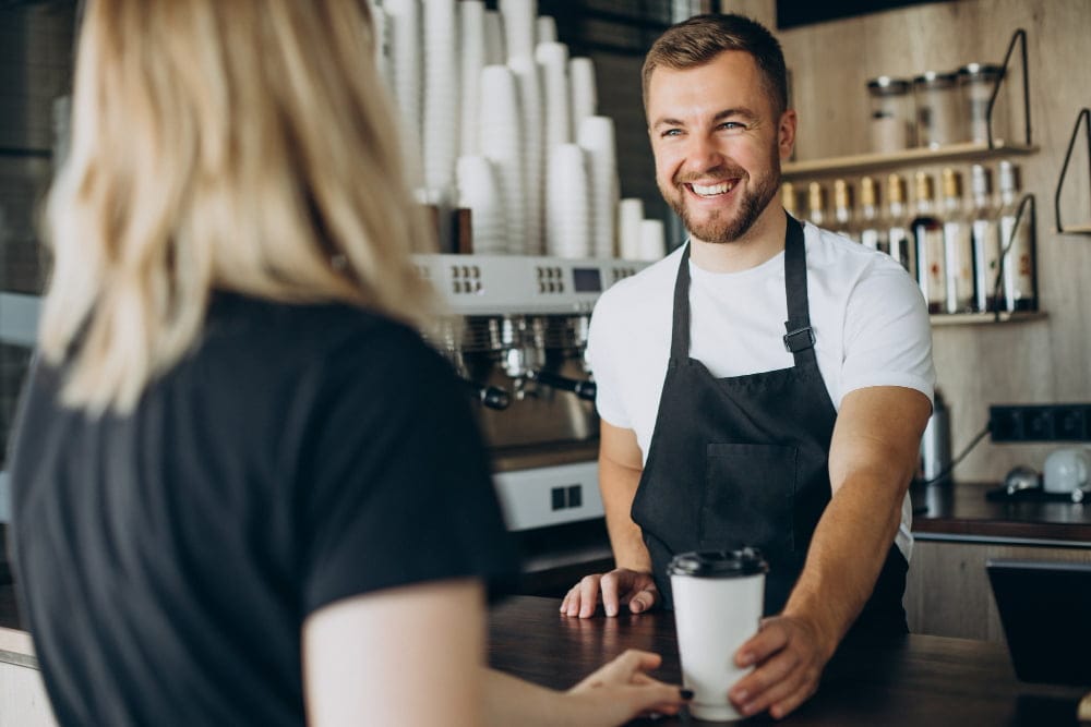 barista-surving-client-with-coffee-coffee-shop